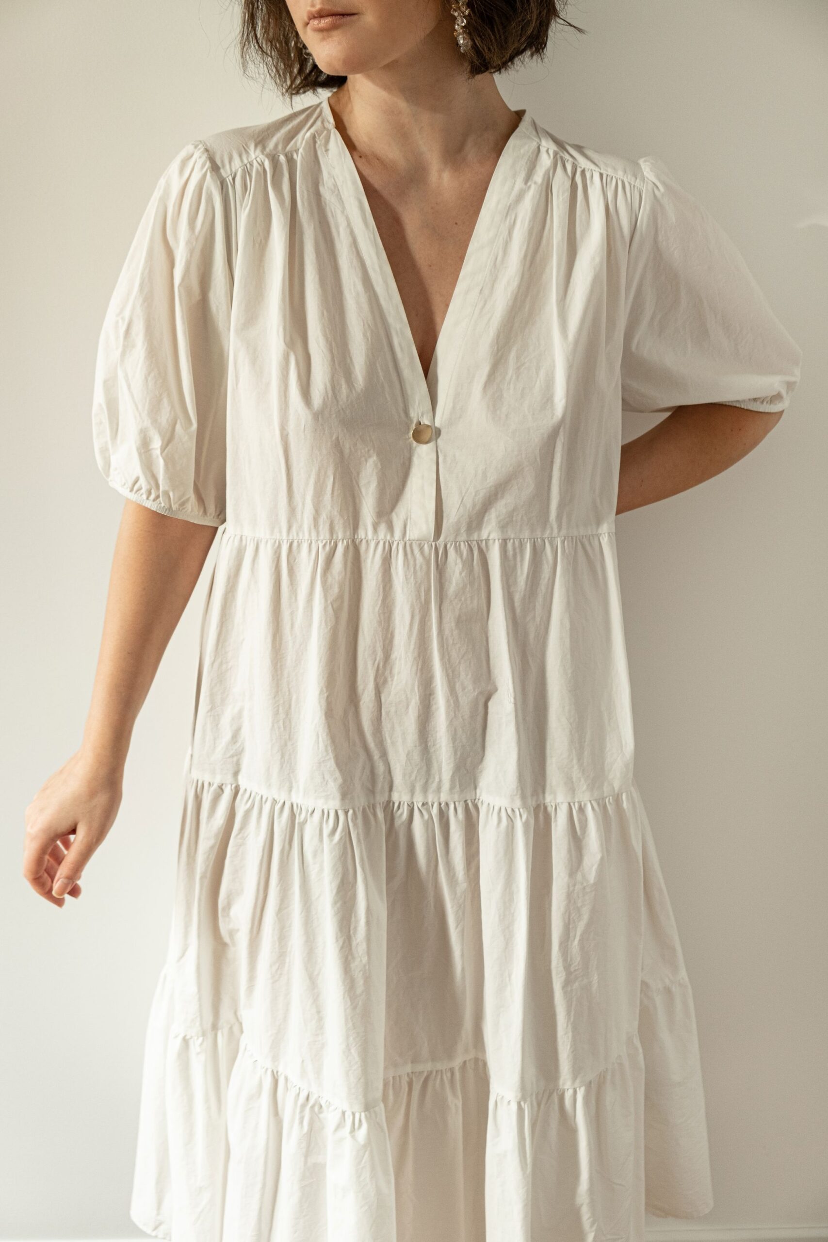 young-pretty-woman-white-dress-sundress-against-wall-minimal-fashion-design-concept
